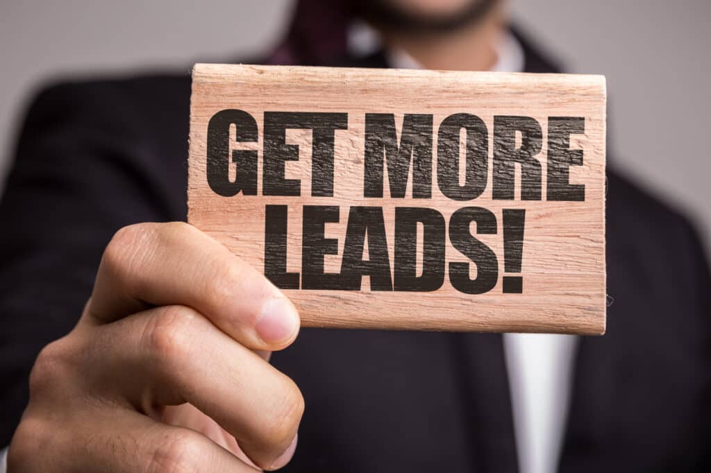 Businessman Holding Up A Sign To Get More Leads For The Business